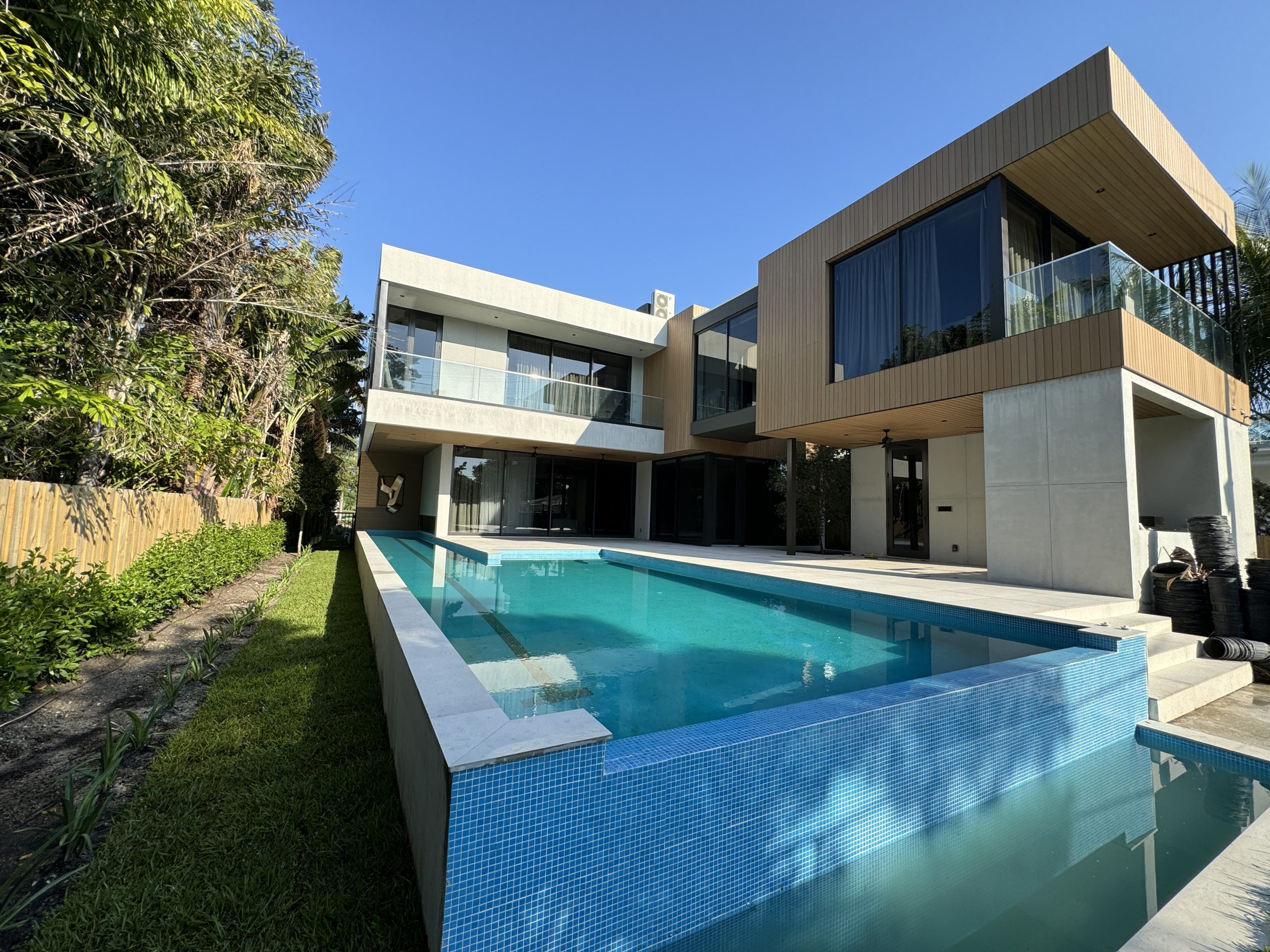 Completed custom home exterior with pool in Miami
